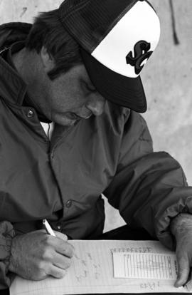 Denny Lorsung fills out a line up card before a St. Cloud State University baseball game against Augsburg College