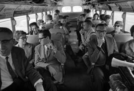 People ride on a bus to the Minnesota Vikings football game at Met Stadium, St. Cloud State University