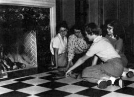 Whitney House residents sit by the Whitney House (1956) fireplace, St. Cloud State University