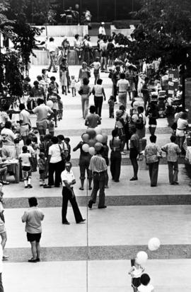 People gather on sidewalks to visit vendors' booths, Lemonade Concert and Art Fair, St. Cloud State University