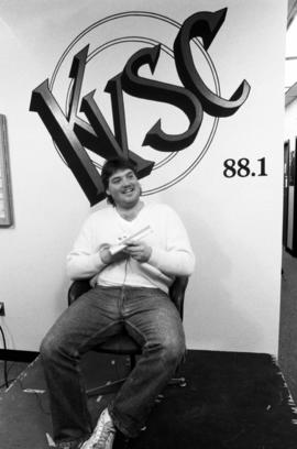 A man sits in a chair during the KVSC trivia weekend, St. Cloud State University