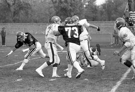 Football player Mike Lambrecht goes for a tackle against University of Nebraska-Omaha, St. Cloud State University