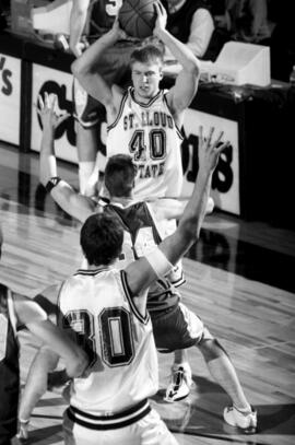 Jason Kron prepares to throw a basketball during a basketball game, St. Cloud State University