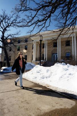 A student walks near Shoemaker Hall (1915), St. Cloud State University