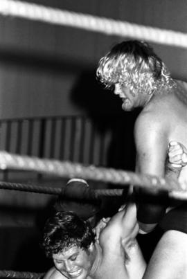 Wrestler Bobby Duncum holds the arm of Jim Brunzell at Halenbeck Hall (1965), St. Cloud State University