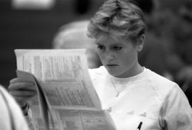 Woman studies a course schedule at registration, St. Cloud State University