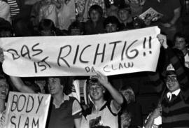 Sign reads "Das Ist Richtig Da Claw" at the wrestling matches at Halenbeck Hall (1965), St. Cloud State University