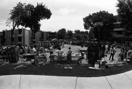 People gather on sidewalks to visit vendors' booths, Lemonade Concert and Art Fair, St. Cloud State University