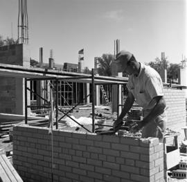 A man lays brick for the construction of the Atwood Memorial Center (1966), St. Cloud State University