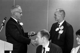 Ralph Heimdahl receives his Distinguished Alumni Award from President Robert Wick