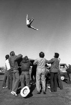 People throw a woman into the air during homecoming, St. Cloud State University