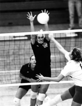 Cami Selbitschka blocks a shot during a volleyball match, St. Cloud State