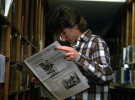 Man reads the Chronicle newspaper in the library, Alnwick Castle, St. Cloud State University