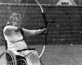 Sue Hagel prepares to shoot an arrow, St. Cloud State University