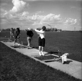 Women hit golf balls at driving range, St. Cloud State University