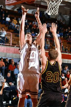 Brad Evans jumps for a basketball during a game, St. Cloud State University