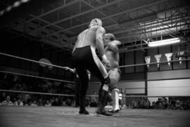 Wrestler Brad Rheingans punches Wayne Bloom during a match at the Sauk Rapids High School