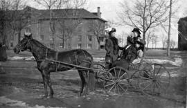 Anna Anderson, Ellen Swanson, and friends ride in a horse-drawn carriage, St. Cloud State University