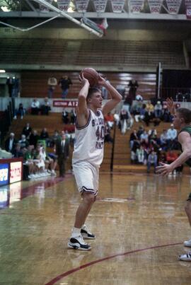 Jason Kron prepares to pass the basketball during a basketball game against the University of North Dakota