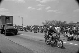 Protestors march on sidewalk, Day of Peace protest, St. Cloud State University