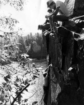Bob Schultz receives encourgement to climb up cliff from fellow climbers at the Taylors Falls State Park, St. Cloud State University