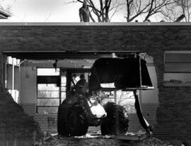 A bulldozer knocks down a portion of Stewart Hall (1948), St. Cloud State University