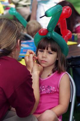 A girl gets her face painted, Lemonade Concert and Art Fair, St. Cloud State University