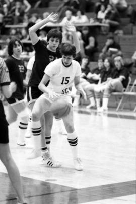 St. Cloud State basketball player Sue Wahl dribbles a basketball during a basketball game against the University of Minnesota-Morris