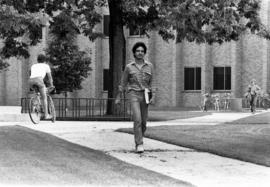 A man walks in front of the School of Business (1968), St. Cloud State University