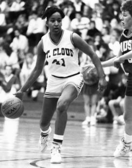 St. Cloud State University basketball player Toni Jameson dribbles the ball