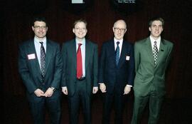 Mark Partridge, Kevin Hassett, and Joseph Newhouse stands with another man at the Winter Institute, St. Cloud State University