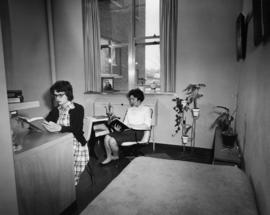 Two students relax in their dormitory room in Mitchell Hall (1958), St. Cloud State University