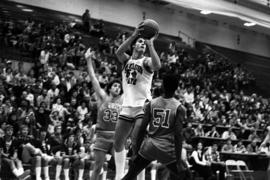 St. Cloud State University basketball player Dan Hagen readys to shoot a basketball in a game against St. John's University