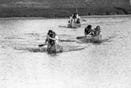 People participate in the homecoming canoe race, St. Cloud State University