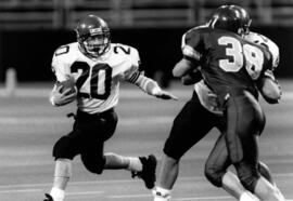 Randy Martin runs with a football during a game, St. Cloud State University