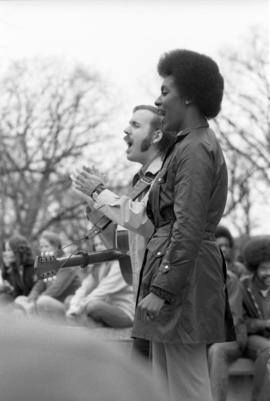 A man and a woman sing, Day of Peace protest, St. Cloud State University