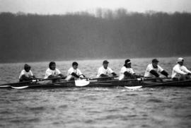 Rowing Club members row on a body of water, St. Cloud State University