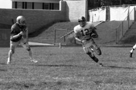 St. Cloud State football player Keith Nord runs with the football in a game against St. Thomas University
