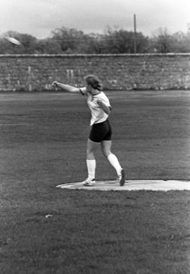 Woman throws a discus at a track and field meet, St. Cloud State University