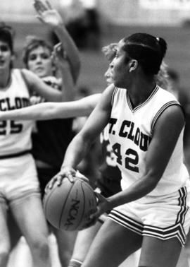 St. Cloud State University basketball player Tami Jameson looks to pass the ball