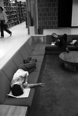 Students sleeping in Centennial Hall's (1971) sunken lounge during finals week, St. Cloud State University