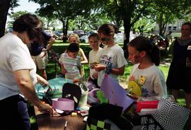 Children gather at table to create artwork, Lemonade Concert and Art Fair, St. Cloud State University