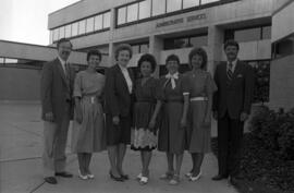Alumni and Development services staff Thomas Macgillivray, Joanne Benson, Mabel Holthaus, Vis Johnson, Roe Moran, Judi Lust, and Brady Watts stand in front of Administrative Services (1975), St. Cloud State University