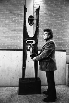 Artist Tony Caponi with his metal sculpture in Atwood Memorial Center (1966) entitled Cathedral, ...