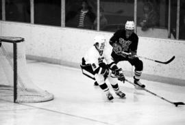 St. Cloud State University hockey player Bruce Laroque handles the puck during a game against the University of Wisconsin-Eau Claire