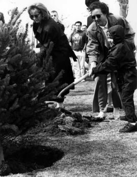 Jessica Ostman and Brandon Thayer plant a tree near of Stearns Hall (1966) in memory of Dennis Thayer, St. Cloud State University