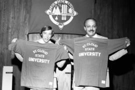 Local state legislators Jim Pehler and Jack Kleinbaum celebrate the name change of the school from college to university, St. Cloud State University