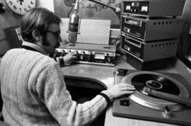 A man broadcasts at KVSC studios, St. Cloud State University