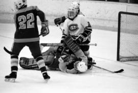 Hockey players gather in front of the net, St. Cloud State University