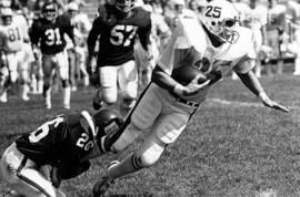 St. Cloud State University football player Gigi Brouillette tackles St. John's football player Joe Butorac